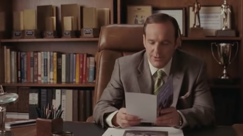 Vance reading sitting at desk