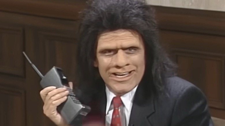 Phil Hartman as Keyrock holding a mobile phone on "SNL" in 1991