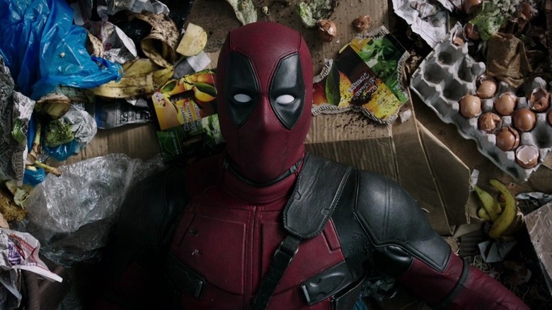 Deadpool lying on garbage