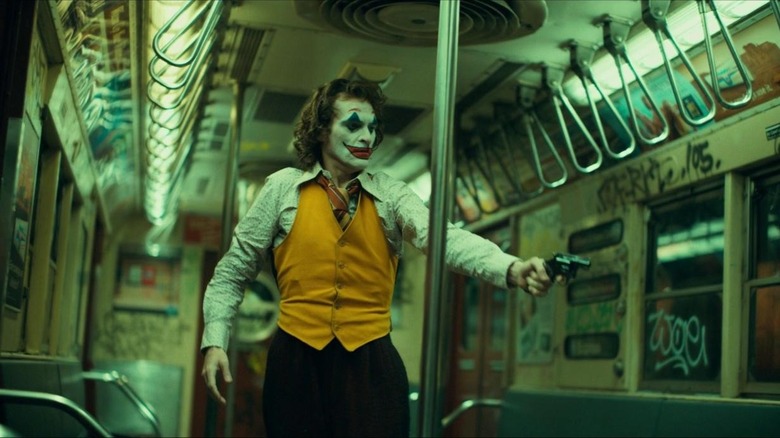 Joker points gun in subway