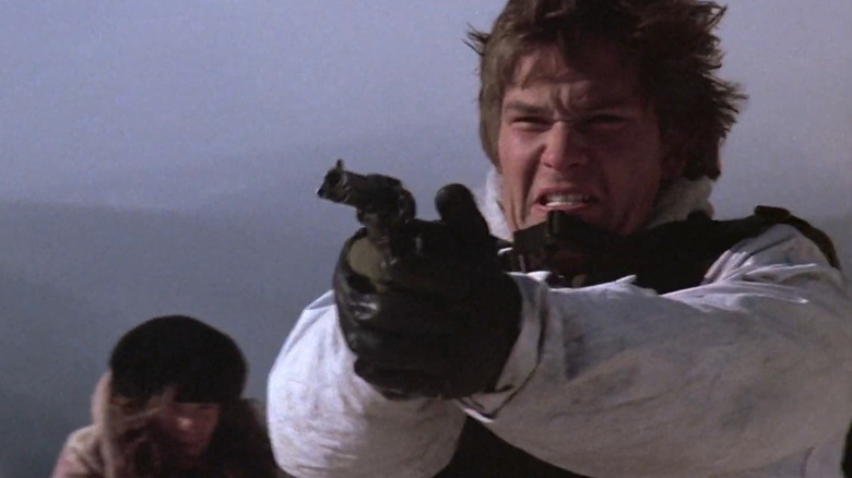 Patrick Swayze aims gun