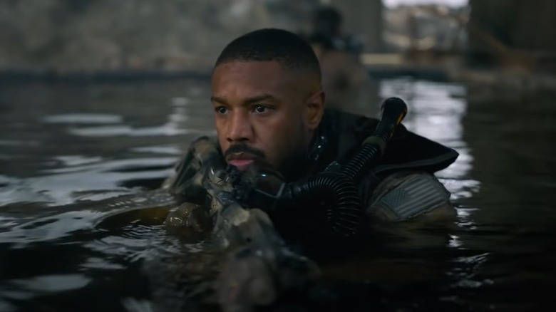 Michael B. Jordan holding a gun