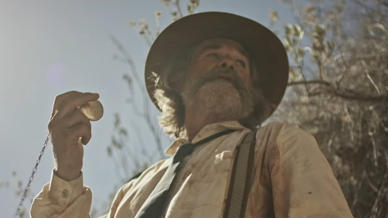 Kurt Russell holding pocketwatch