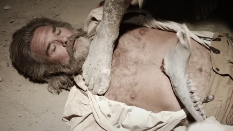 Kurt Russell with foot on chest