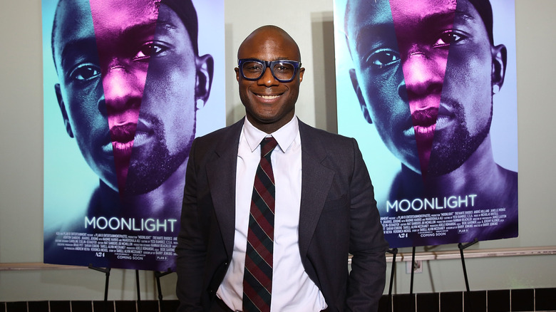 Barry Jenkins flanked by Moonlight posters