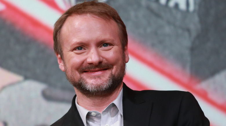 Rian Johnson smiling on red carpet