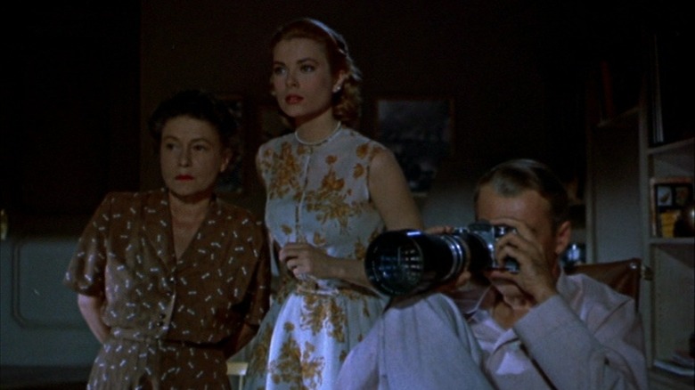 Grace Kelly, Thelma Ritter, and Jimmy Stewart looking