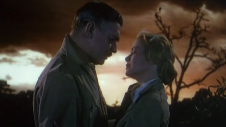 Grace Kelly faces Clark Gable in front of African sunset