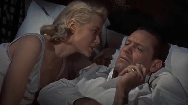 Grace Kelly talking to William Holden in bed