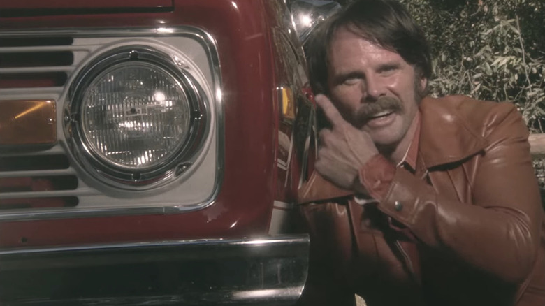 John Bronco smiling with car