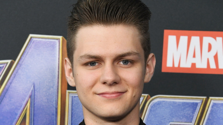 Ty Simpkins smiles on the Endgame red carpet