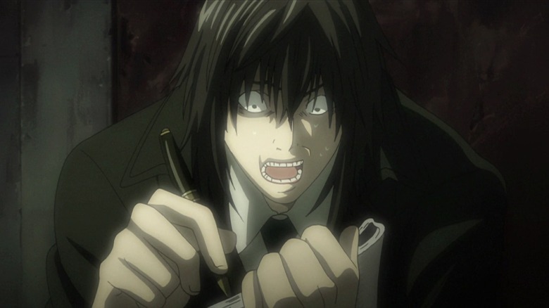 Mikami frantically writing in Death Note