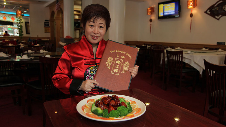 a woman, a menu, and General Tso Chicken