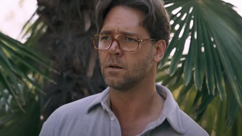 Russell Crowe in glasses in front of tree