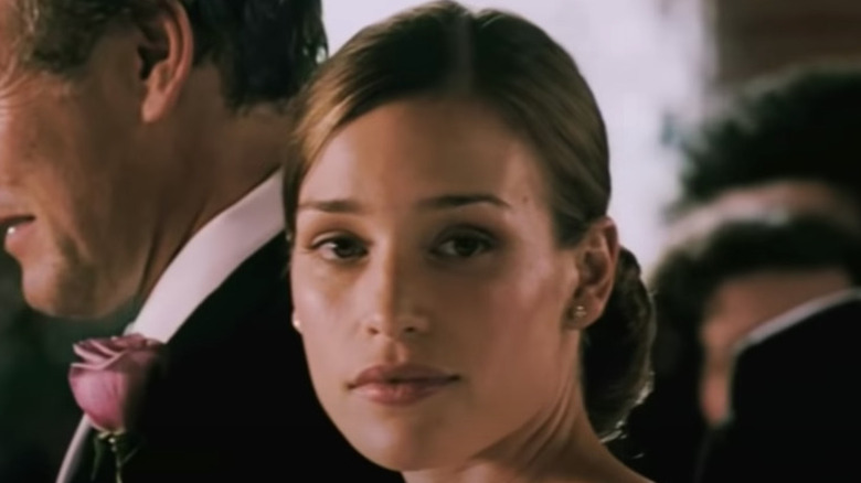 Piper Perabo in wedding dress looks to the side