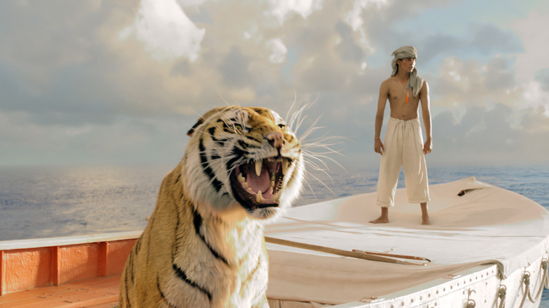 A boy in a boat with a tiger