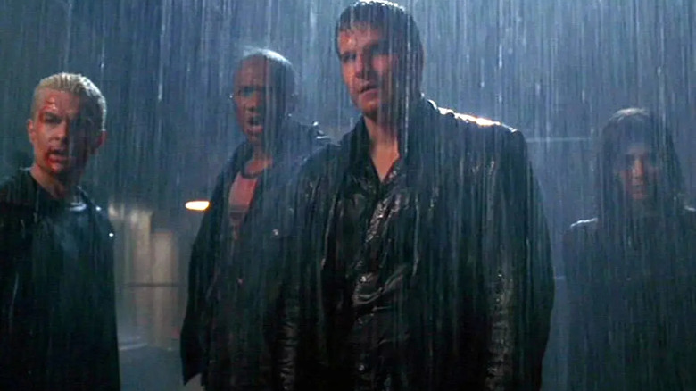 Spike, Gunn, Angel, and Illyria stand in the rain