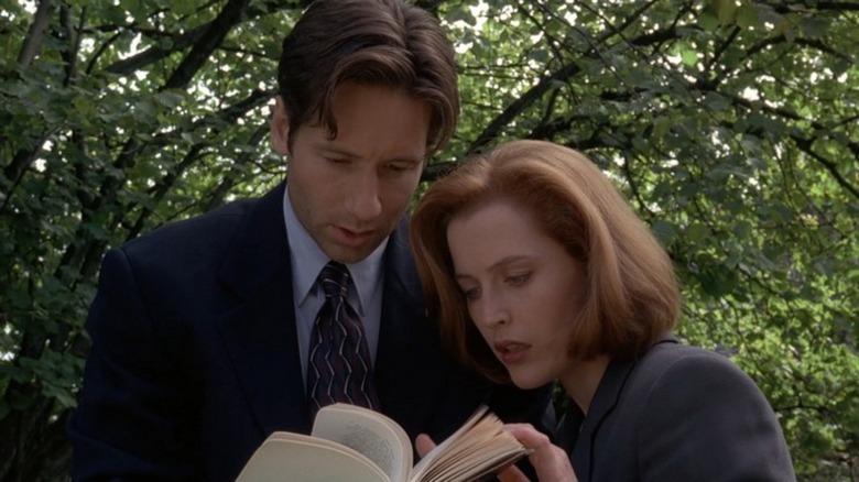 Mulder and Scully flip through a book