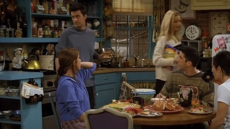 Rachel, Chandler, Phoebe, Ross, and Monica in the apartment