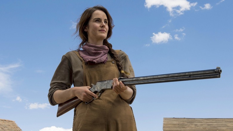 Michelle Dockery holds rifle