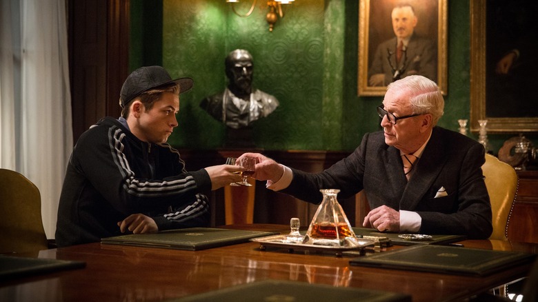 Taron Egerton and Michael Caine toasting