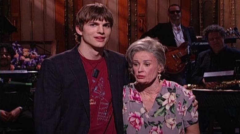 Ashton Kutcher onstage with then-girlfriend Demi Moore dressed as old lady