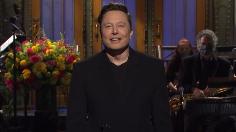 Elon Musk onstage during his SNL monologue