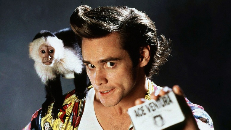 Ace Ventura brandishing business card