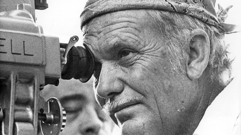 Sam Peckinpah looking through a camera 