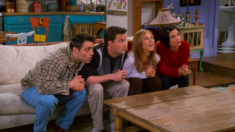 Joey, Chandler, Rachel, and Monica sit on the couch and look up