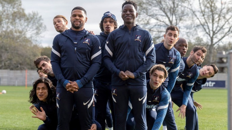 AFC Richmond perform a song on the field