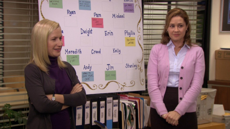 Angela and Pam stand in front of a resolution board