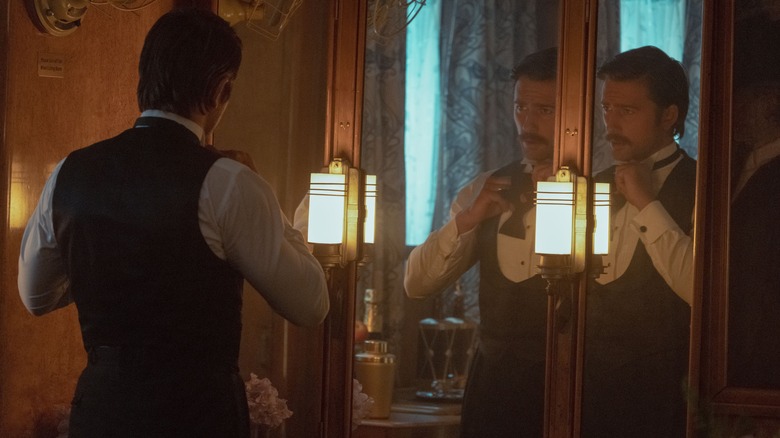 Brandon Sklenar as Spencer Dutton getting dressed before a mirror 