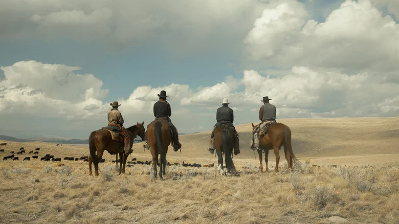 1923 cast on horseback looking over plains