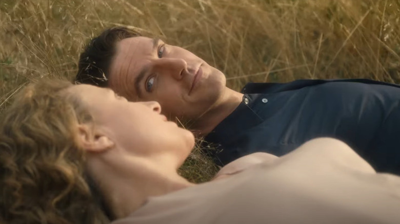 Maren Eggert and Dan Stevens in the grass 