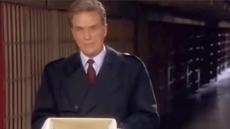 Robert Stack hold up a dummy head