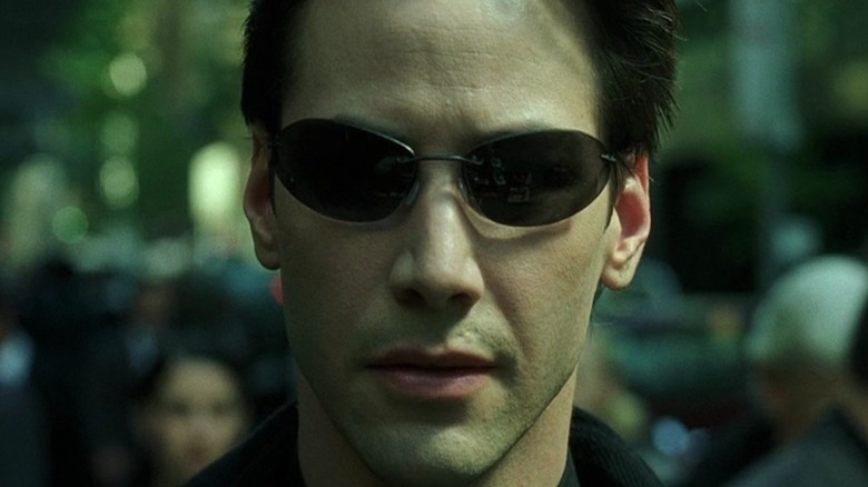 Keanu Reeves looks around as Neo in The Matrix