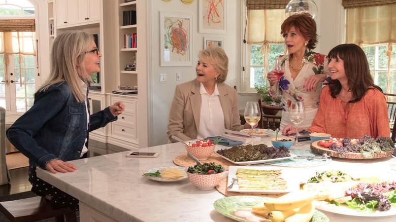 Women talk in a kitchen