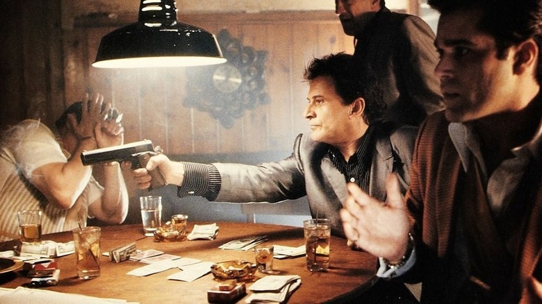 Tommy DeVito pointing a gun