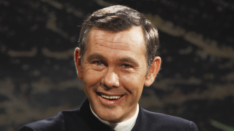 Johnny Carson smiling at mic