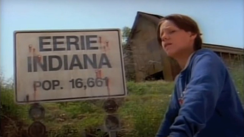 Marshall standing in front of Eerie, Indiana sign