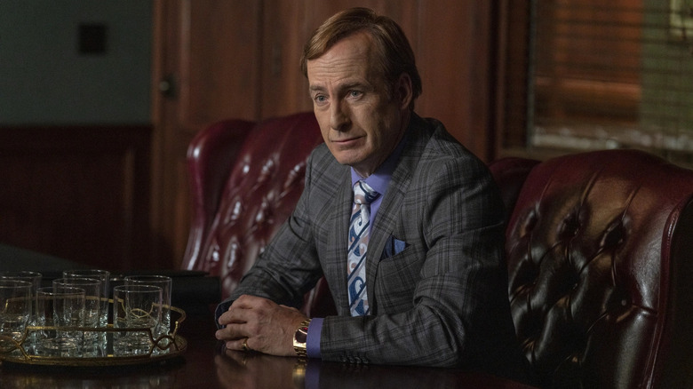 Odenkirk leans forward in a chair