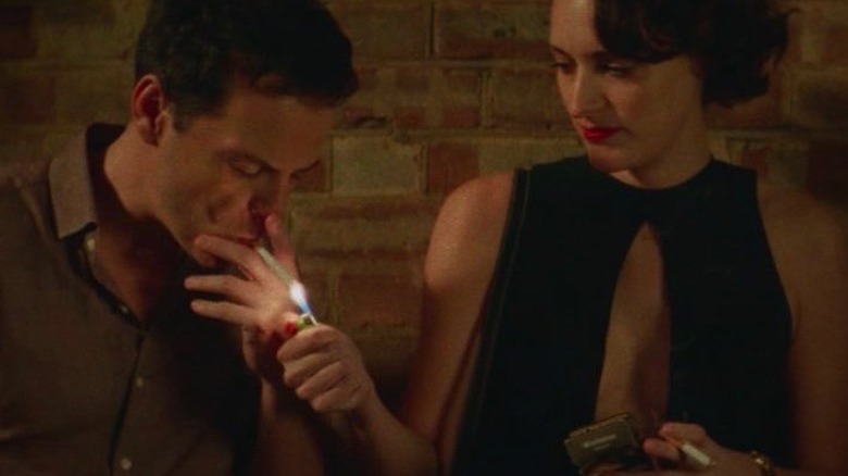 Fleabag lights a cigarette