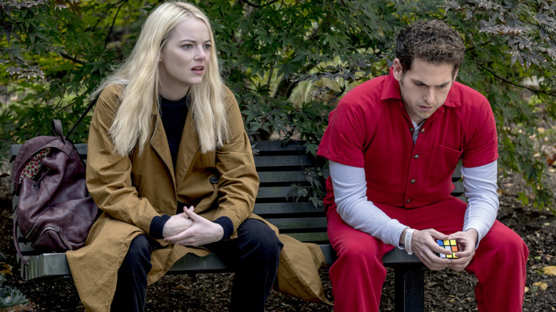 Annie and Owen sit on a bench outside the mental hospital