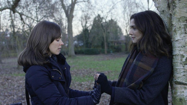 Ronit and Esti hold hands outside in Disobedience (2017)