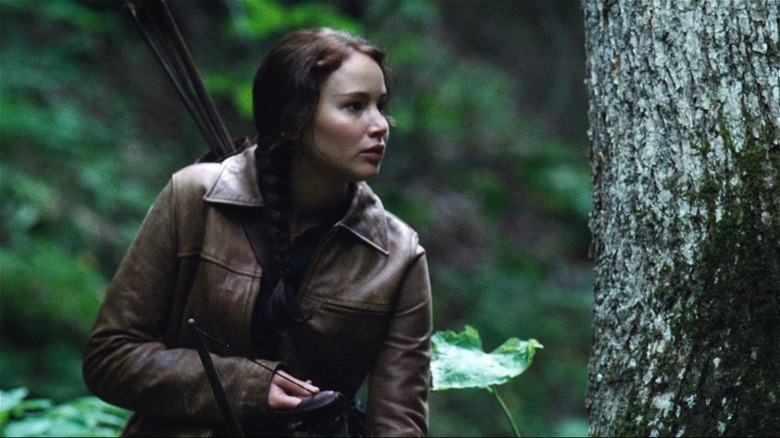 Katniss hunting with her bow