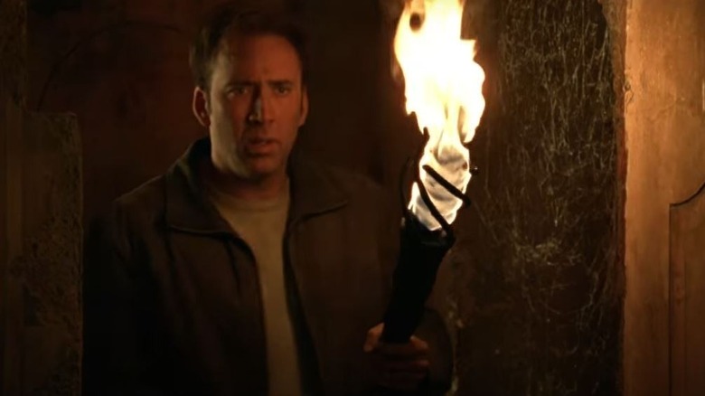 Nicolas Cage holding torch