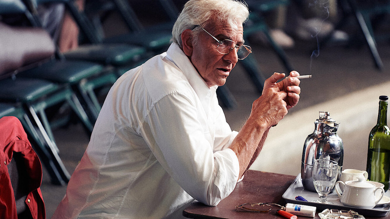 Leonard Berstein sitting at a desk during a rehearsal