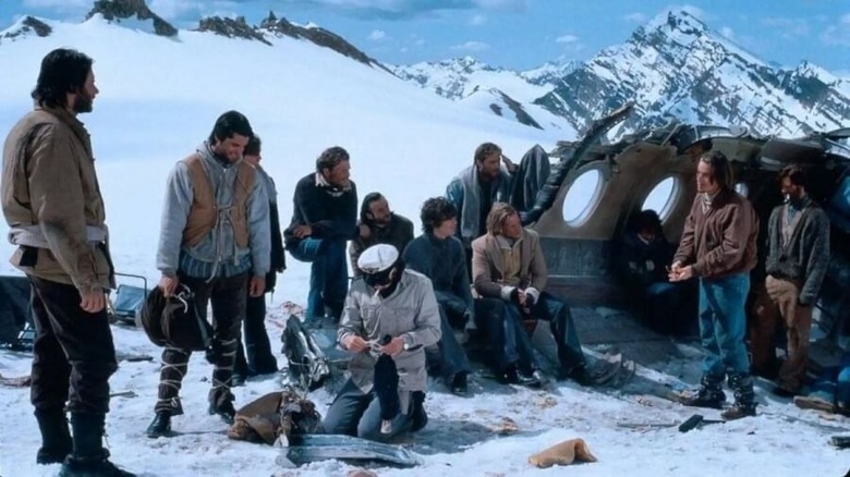 Survivors of the Andes plane crash crowding around the wreckage