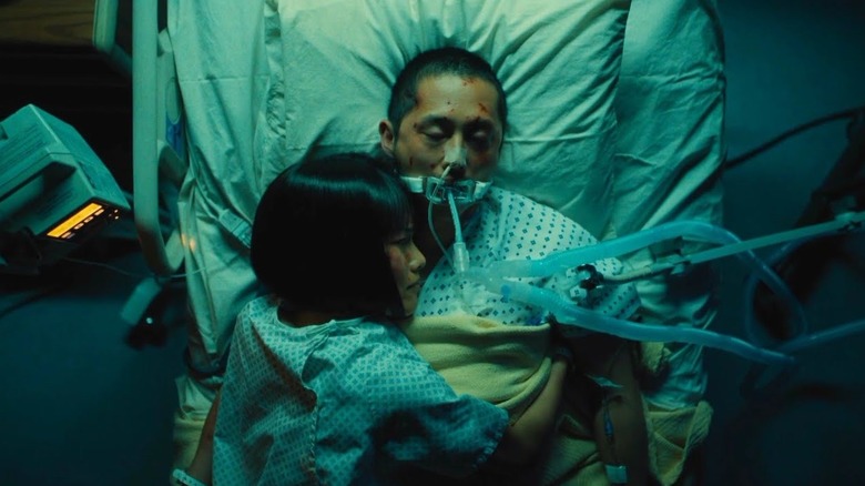 Amy hugging Danny in a hospital bed